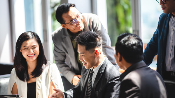 group of professionals discussing ideas in a modern office setting collaborative meeting three people engaged in conversation
