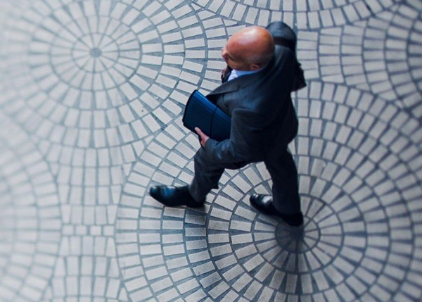 businessman walking on pavement with briefcase stylish professional appearance